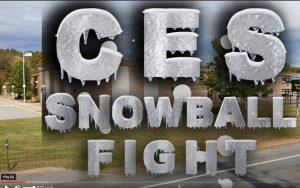 The letters CES Snowball Fight . Background is a brick building.