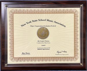 A close up of an award that says New York State School Music Association. Major Organization Evaluation Festival Gold Award Fifth Grade Chorus conducted by Mary Sousa Level 1.