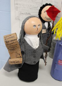 A soda bottle decorated as ben franklin.