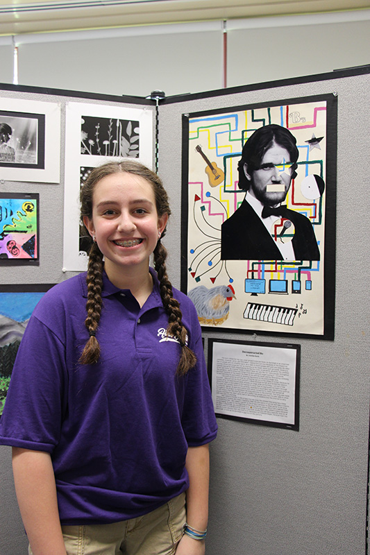 A young woman with long dark braids smiles as she stands in front of her deconstructed photo.