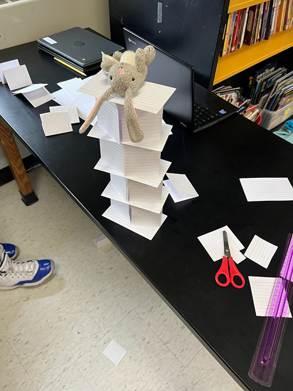 View from the top - a tower made of index cards with a little stuffed rabbit on top.