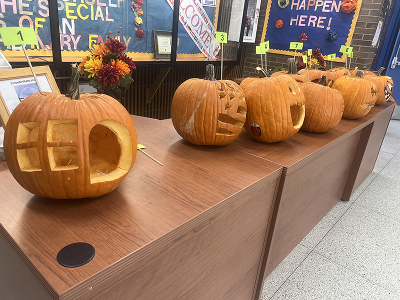 A desk with carved pumpkins on it.