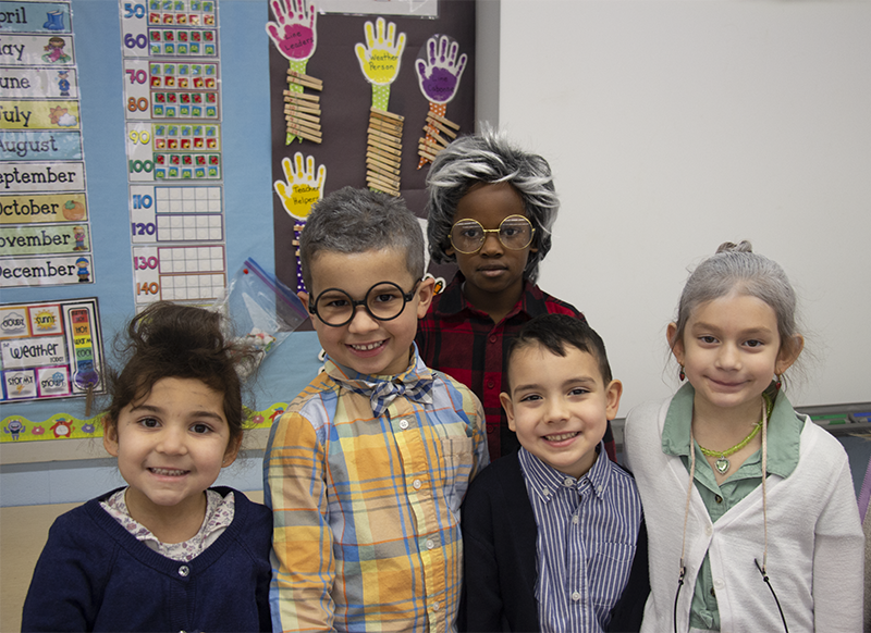 A group of five kindergarten kids all dressed as old people.