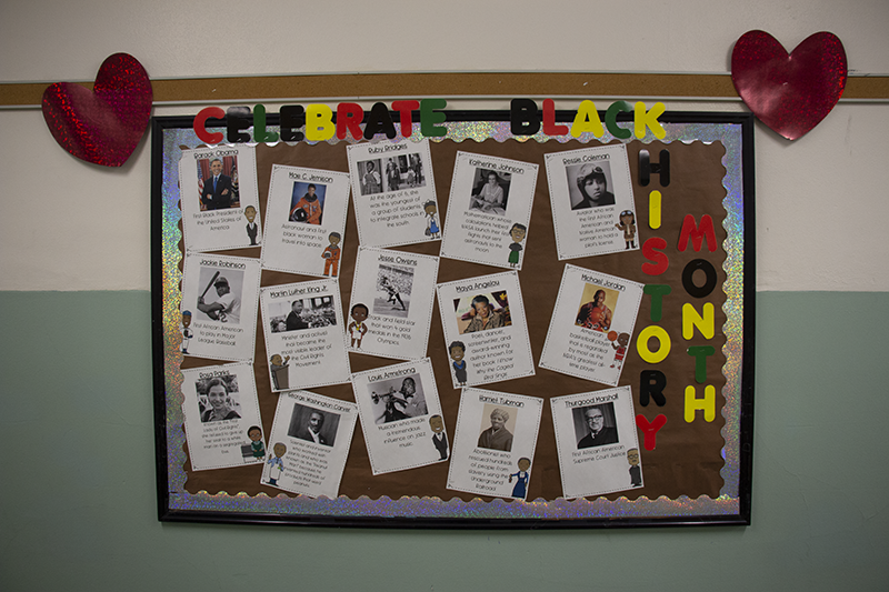 A bulletin board with 15 pages containing influential black americans. The boarder says Black History Month